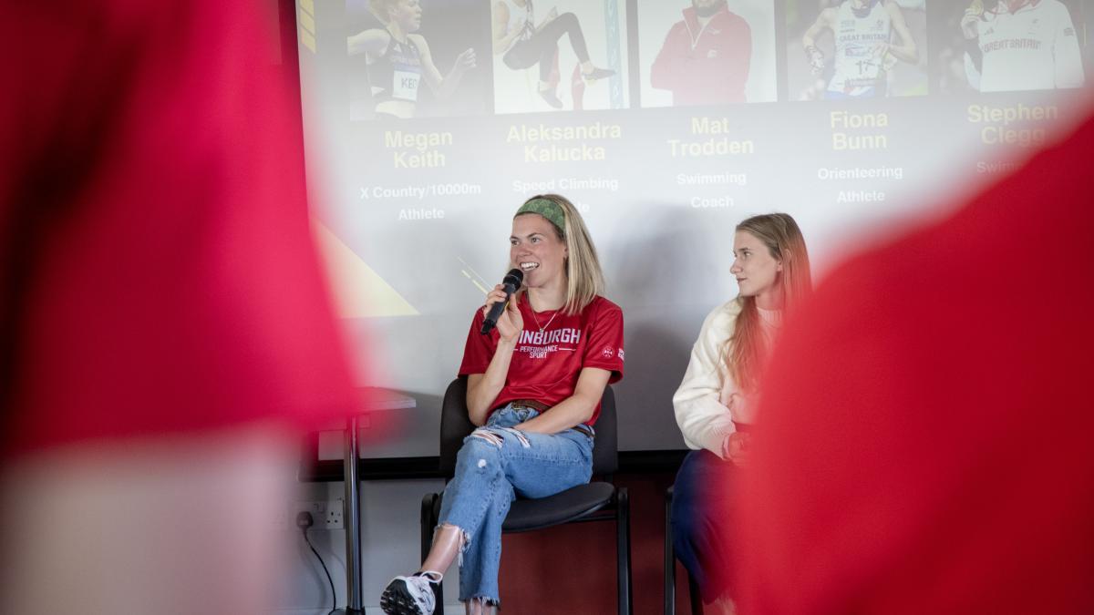 Image of Megan Keith smiling holding microphone