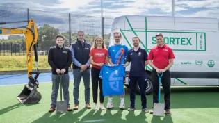 Image of staff from Sportex, Scottish Hockey and Edinburgh University on hockey pitch in front of tractor and sportex recycling van