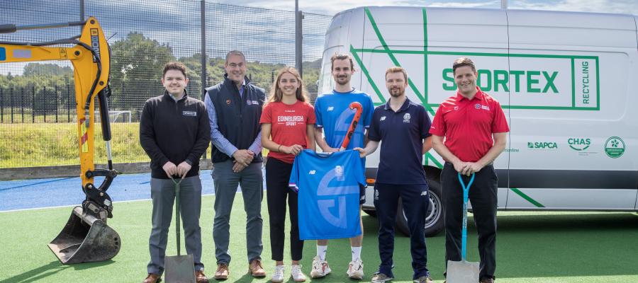 Image of staff from Sportex, Scottish Hockey and Edinburgh University on hockey pitch in front of tractor and sportex recycling van