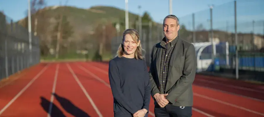 Image of Eilidh Doyle with Mark Munro at Peffermill Playing fields running track