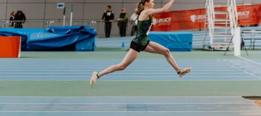 women running up to long jump