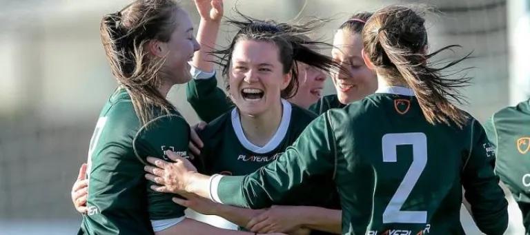 Women's sports team hugging
