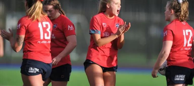 Players from women's sports team on pitch