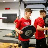 Two gym members preparing weights