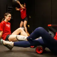 Three gym members in various stages of workout