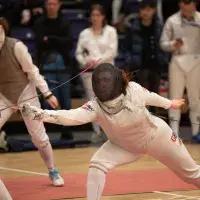 person lunging in a fencing match