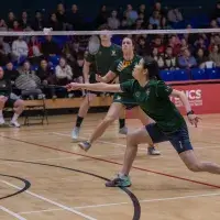 person playing badminton in a double match
