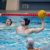 Boy throwing water polo ball in a match