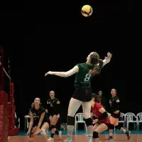 woman jumping to hit volleyball in the air