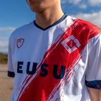 white sports kit with red diagonal line and logo