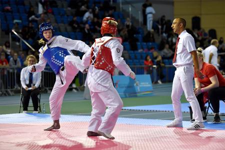 Taekwondo competition, Emily kicking opponent 