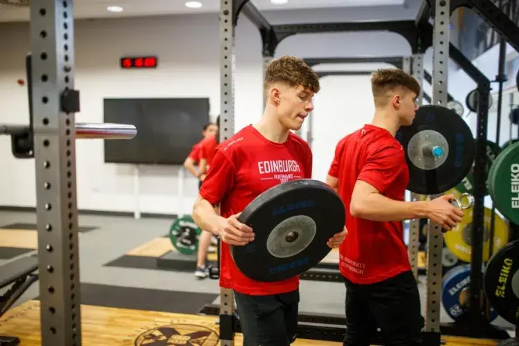 Two gym members preparing weights