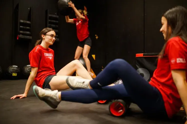 Three gym members in various stages of workout