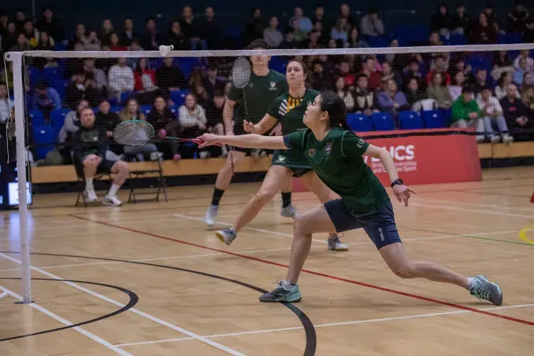 person playing badminton in a double match