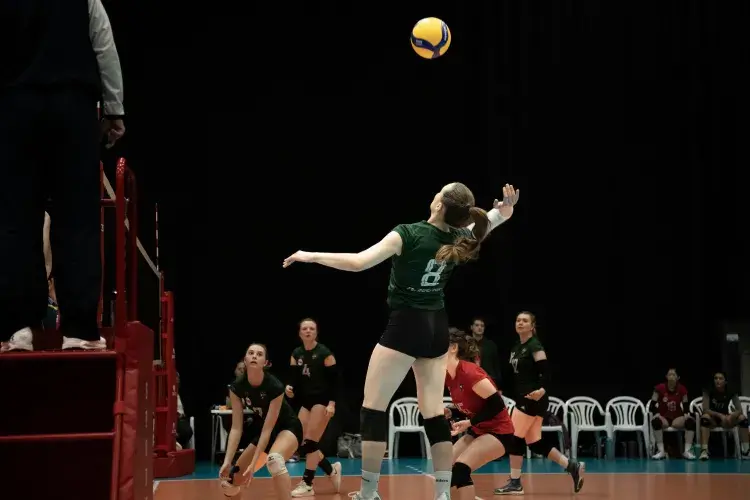 woman jumping to hit volleyball in the air