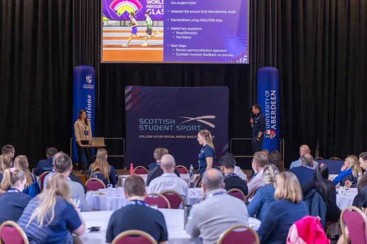 Katherine presenting on stage at SSS conference