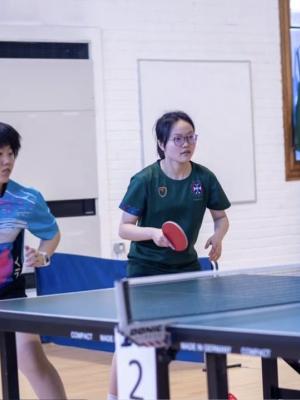 2 people playing doubles in table tennis