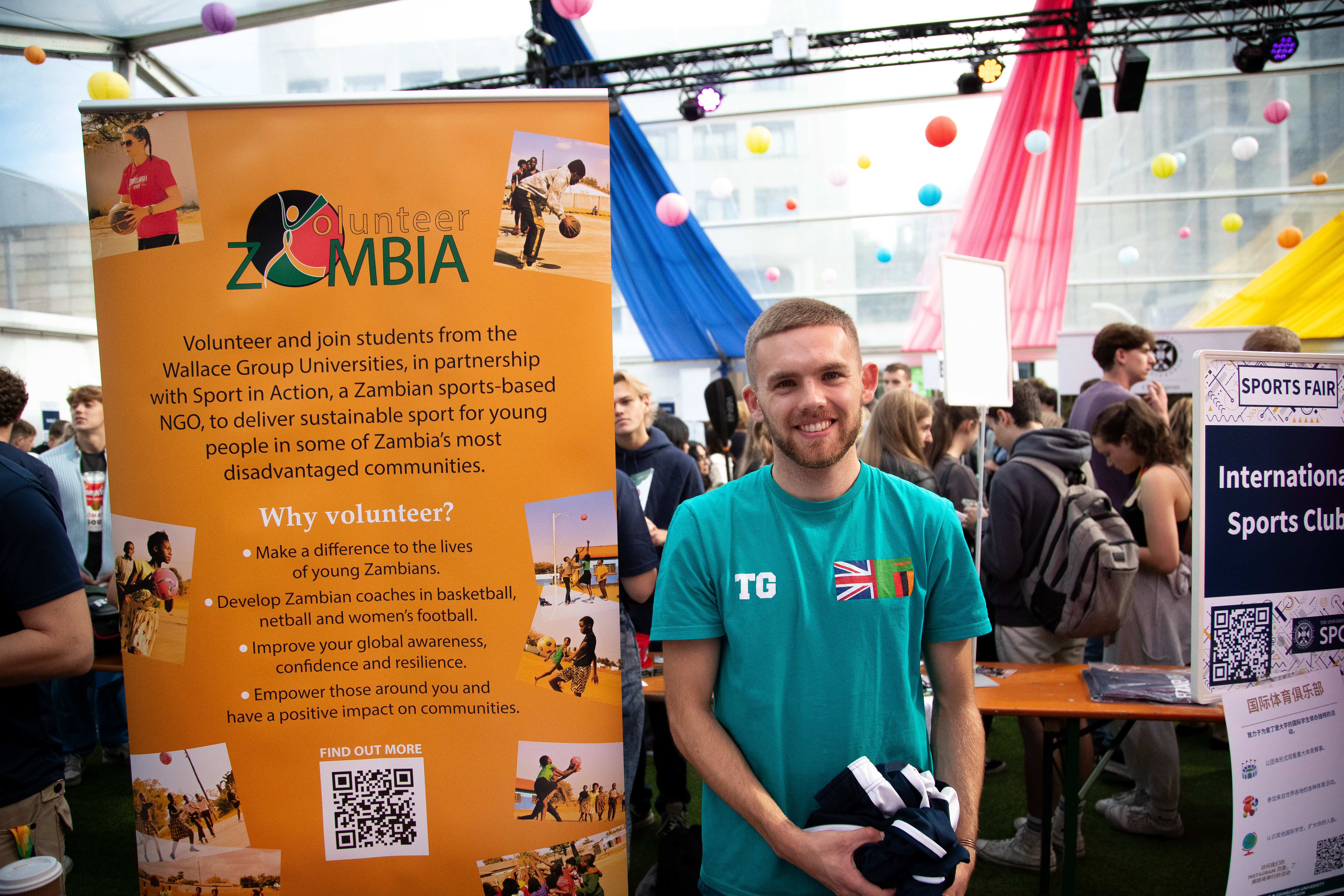 Student with Volunteer Zambia Pull Up banner