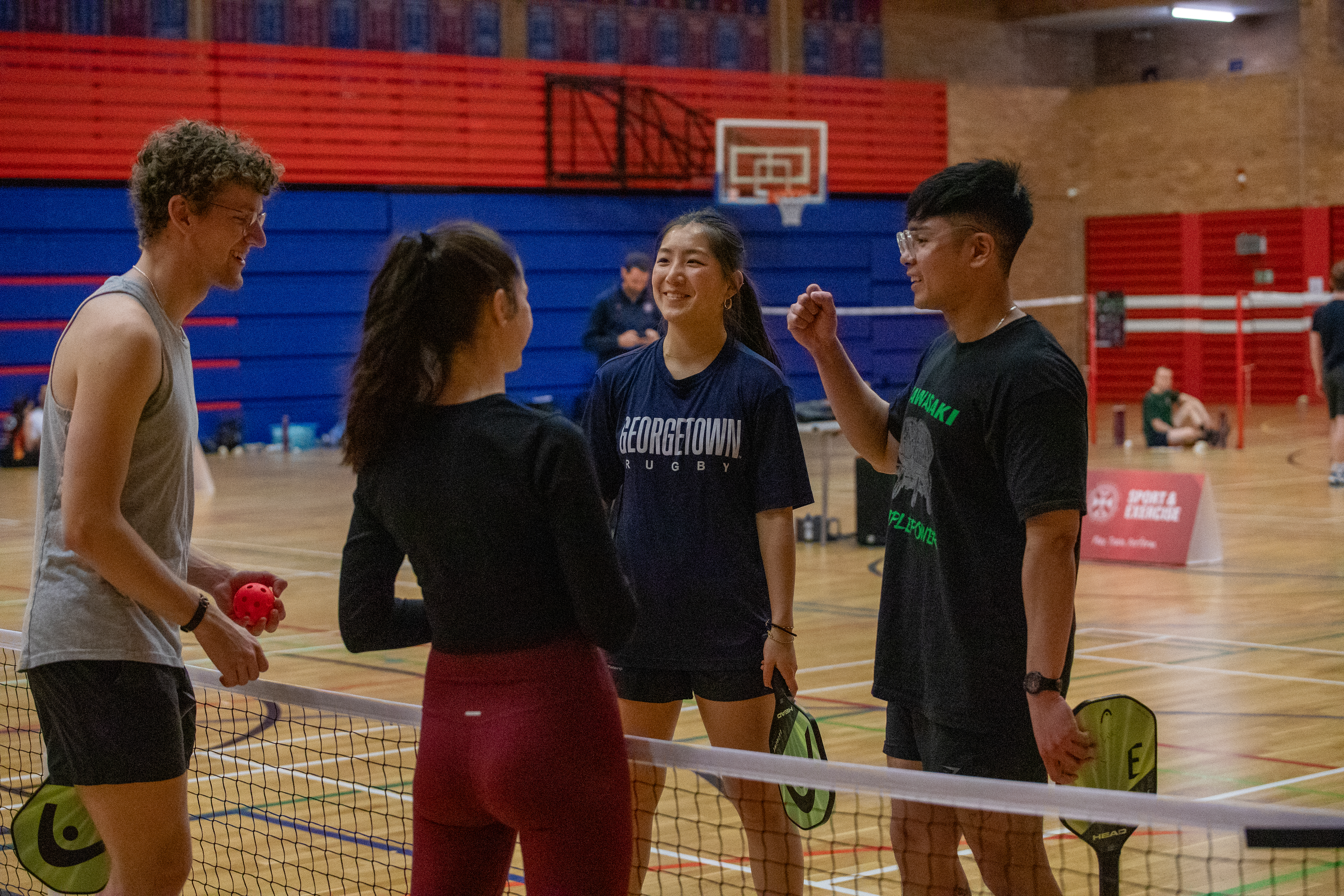 Teams talking at net after pickleball match