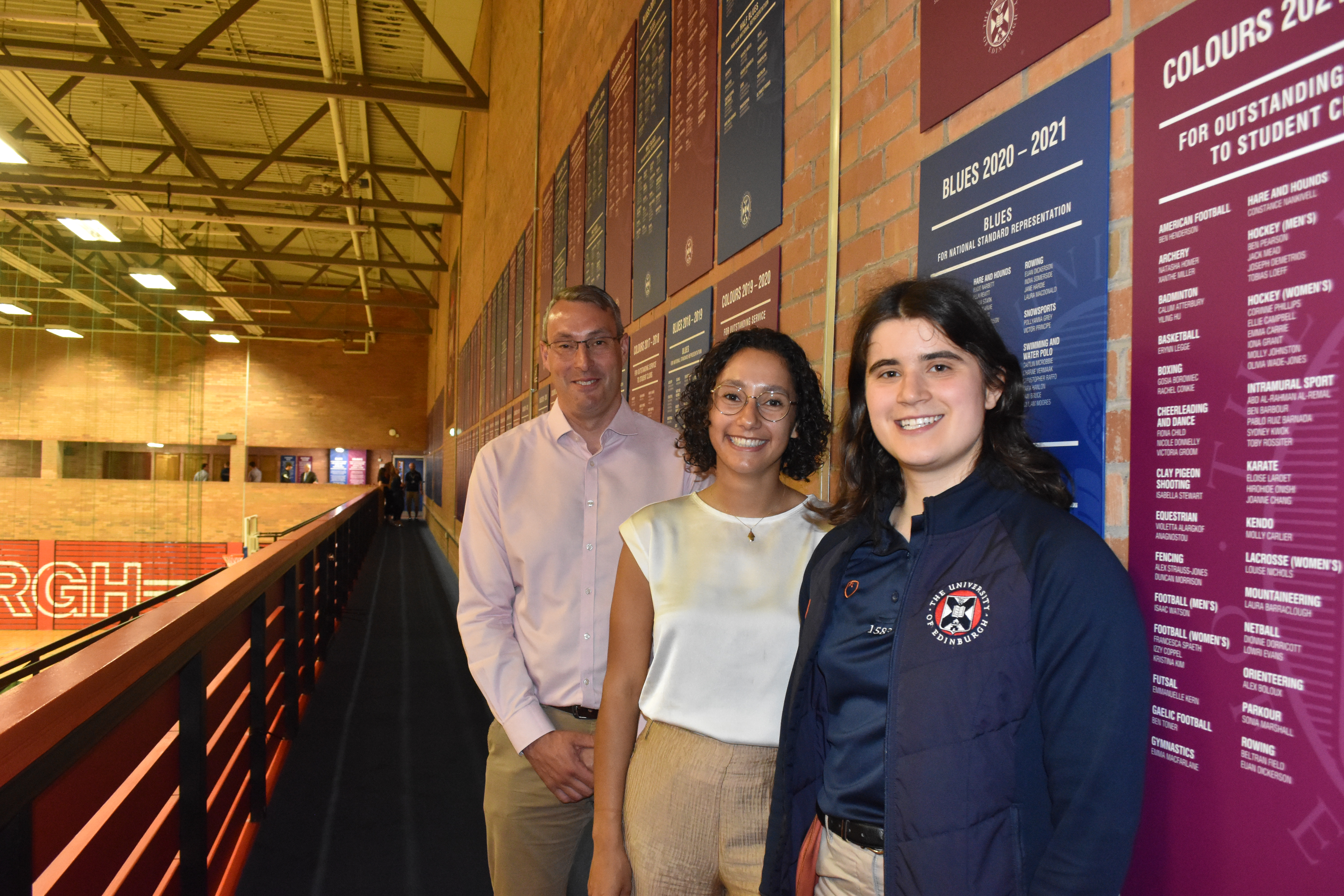 Image of Mark Monroe, Cecilia Bosman and Heather Gault standing at Cecilia's Blues and Colours Board in the gallery